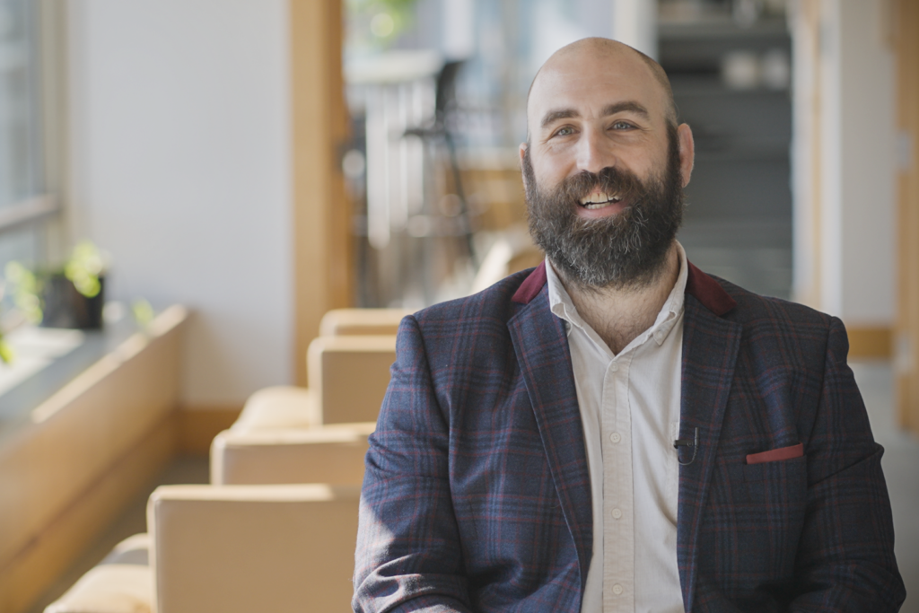 Senior Measurement Scientist Christopher Runyon, PhD smiling at camera